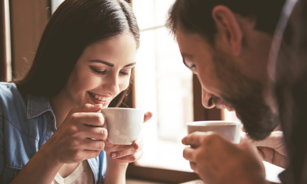 couple drinking coffee in coffeehouse