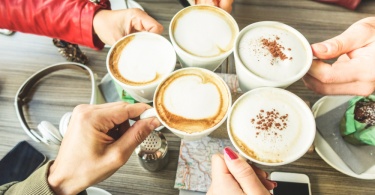 friends toasting with cappuccinos