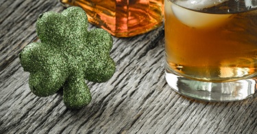 Glass of Whiskey and Clovers to celebrate St Patrick's Day