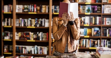 Woman reading book standing up