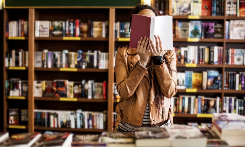 Woman reading book standing up