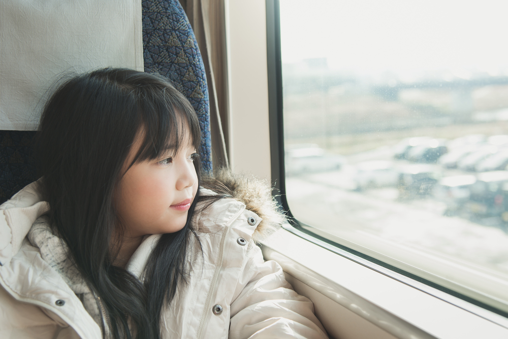 young girl looking out of a window