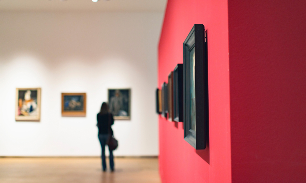 Room in museum with artworks and visitor.