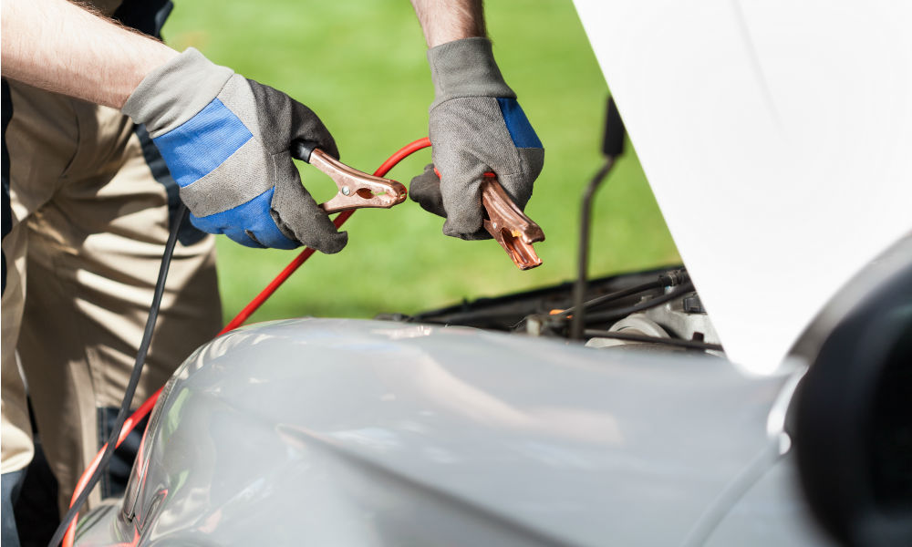 man-using-jumper-cables-on-a-car