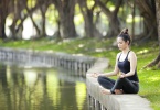 woman-meditating-by-a-pond