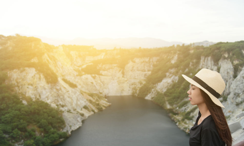 Young woman facing a canyon