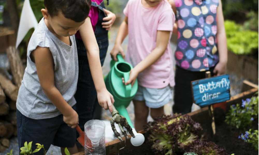 Group of kids watering the plants