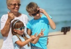 grand-mother-with-grandkids-on-beach