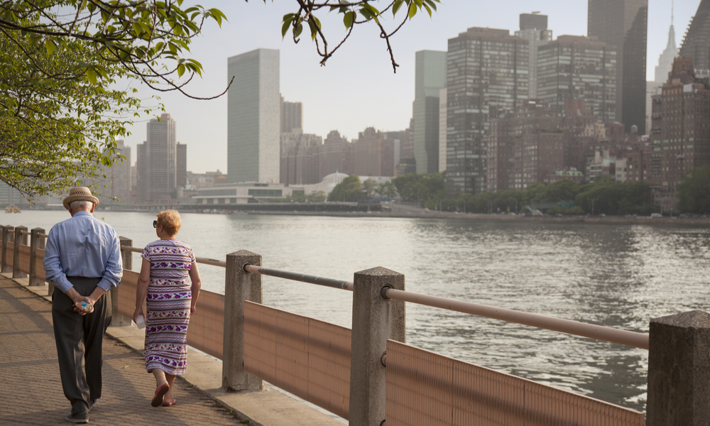 older couple walking along park path