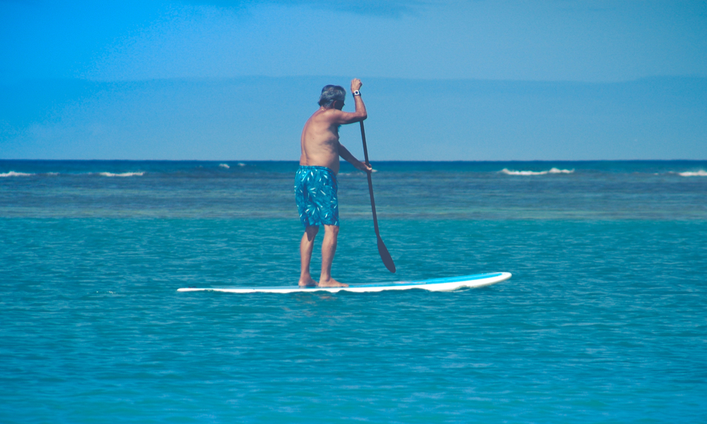 Senior Exercising On A Standup Paddleboard