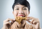 woman to eat deep fried chicken.