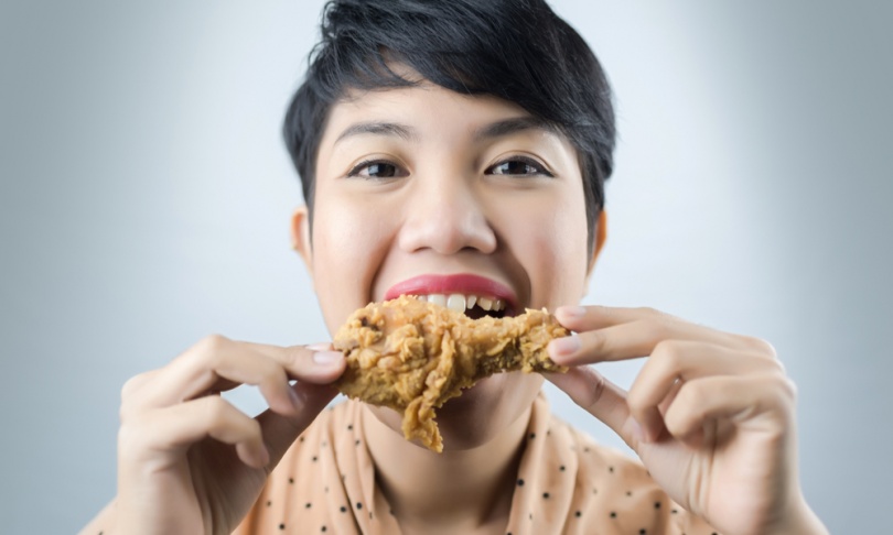 woman to eat deep fried chicken.