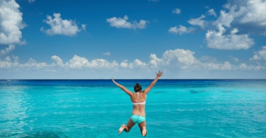 girl-jumping-into-ocean