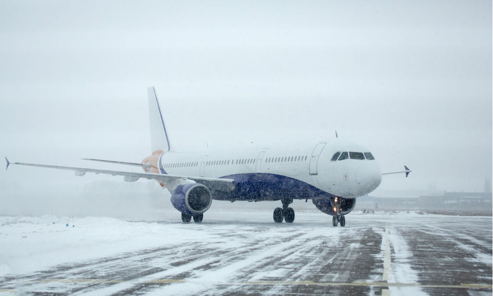 plane on runway in bad weather