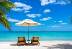 turquoise sea, deckchairs, white sand and palms, sun, very beautiful nature