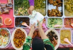 Buying food.Variety of delicious Malaysian home cooked dishes sold at street market stall in Kota Kinabalu Sabah from top angle view