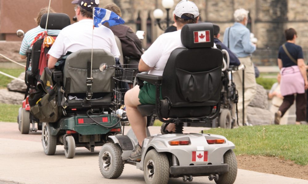 Tourists in electric wheelchairs on Parliament Hill. Ottawa, Ontario. Canada.