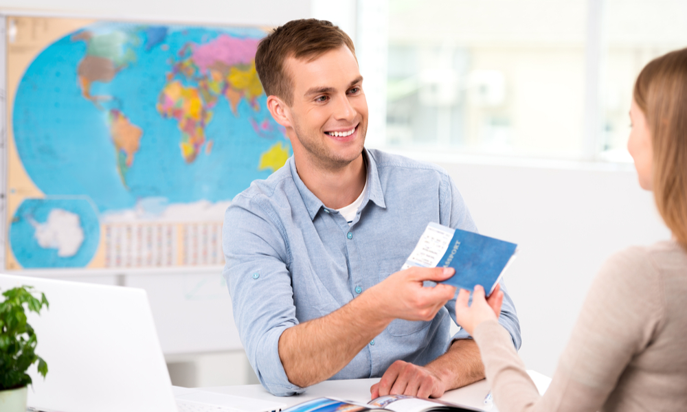 travel agent handing over passport and documents to traveler