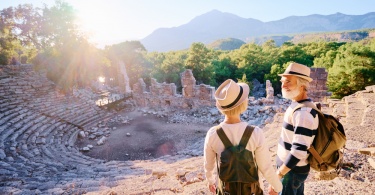 Senior family couple enjoying view together on ancient amphitheatre.