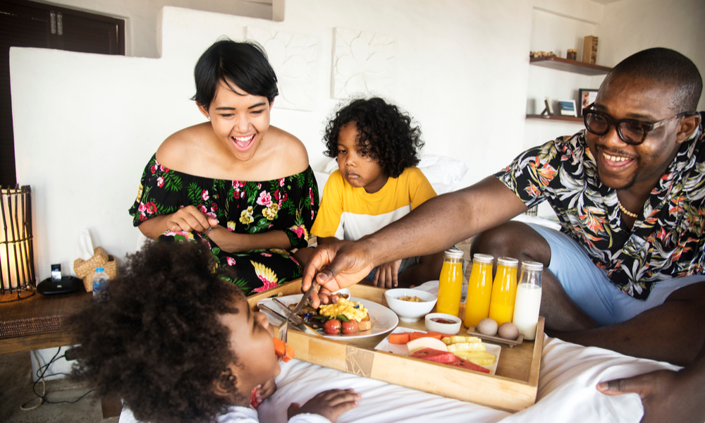 family having breakfast in bed