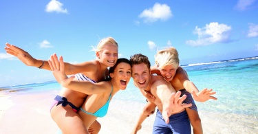 Family of four having fun at the beach