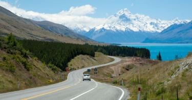 Beautiful landscape of car, road, lake and snow mountain in South Island, New Zealand