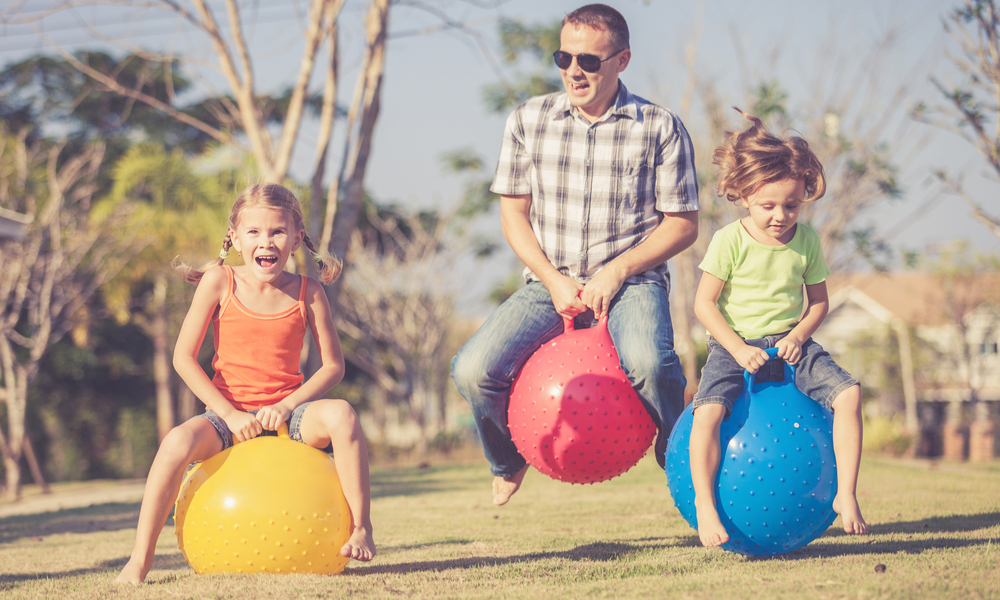 father playing with two daughters 