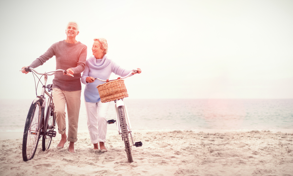 senior travelers on beach