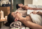 Young man and woman lying down on massage beds at Asian luxury spa and wellness center