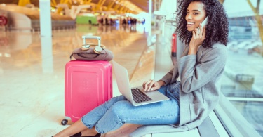 Young woman on the phone in airport