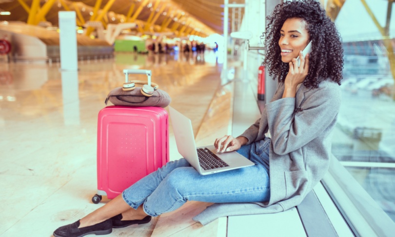 Young woman on the phone in airport