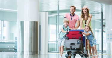 family traveling through airport