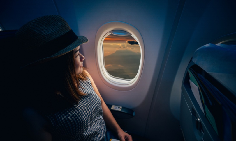 traveler looking out airplane window