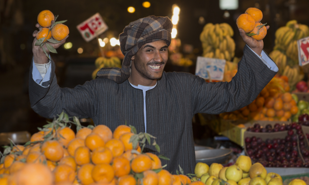 Arabian Egyptian Vendor men selling fruits and vegetables in market at night mood in Cairo Egypt