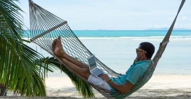 man in a hammock on the beach