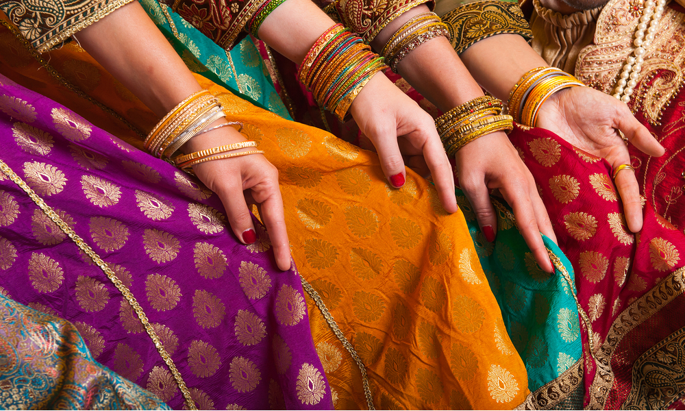 Indian woman holding their saris