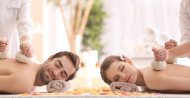 Young happy couple having massage in spa salon