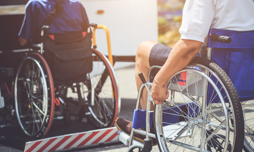 Disabled people sitting on wheelchair and going to the public bus