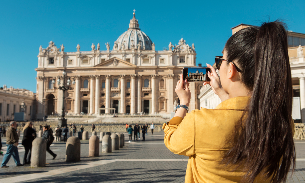 Young Asian woman taking a picture on St. Peter's Square