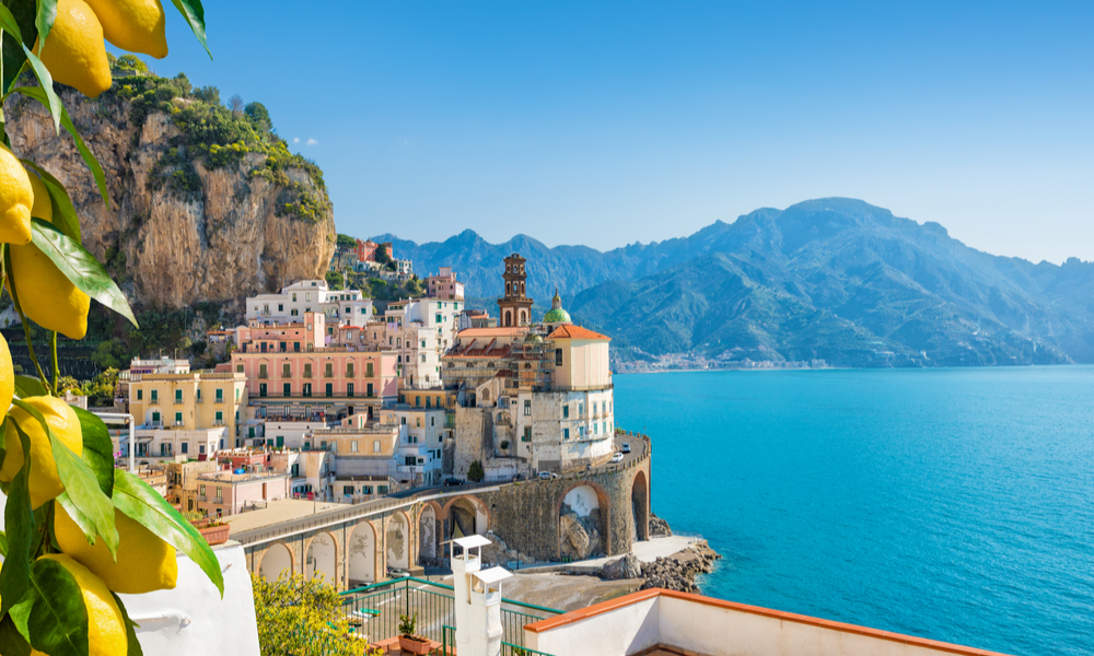 Small city Atrani on Amalfi Coast in province of Salerno, Campania region, Italy. Amalfi coast on Gulf of Salerno is popular travel and holyday destination in Italy. Ripe yellow lemons in foreground.