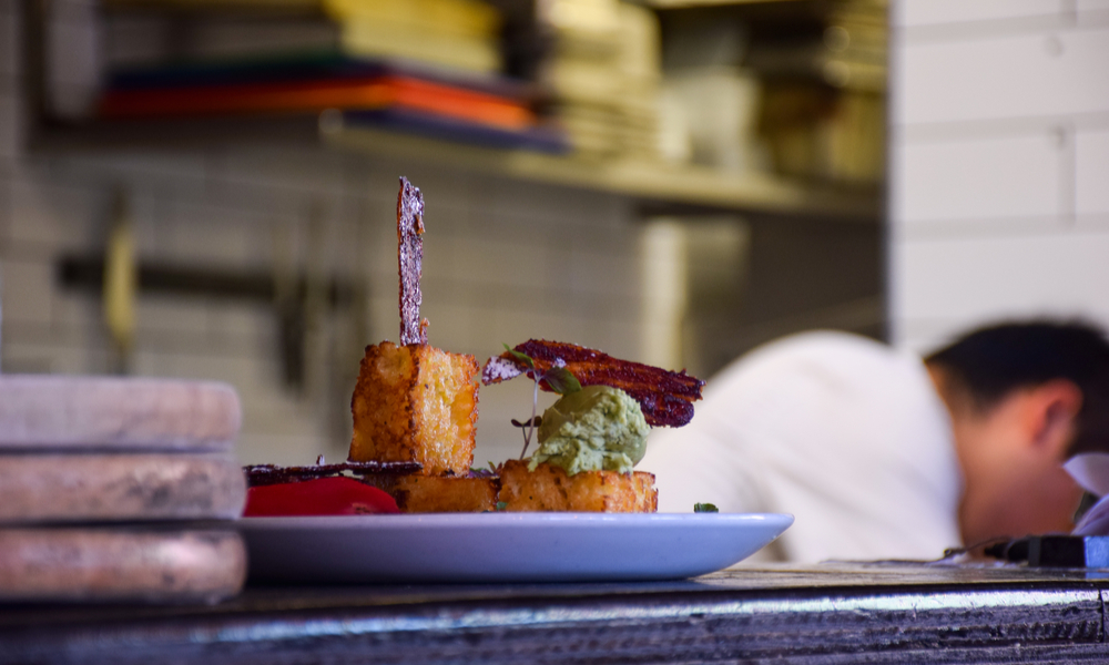 The bread is on the white dish is on bar in restaurant in Melbourne, Australia