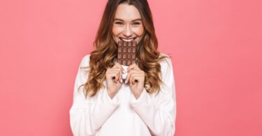 Woman eating chocolate bar