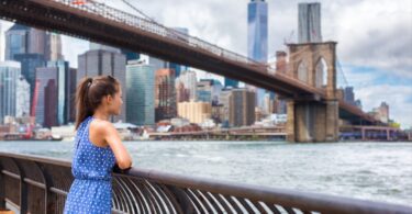 Girl admiring Manhattan from Brooklyn