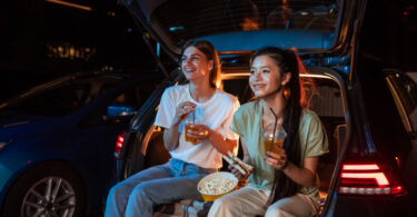 girls enjoying a movie outdoors