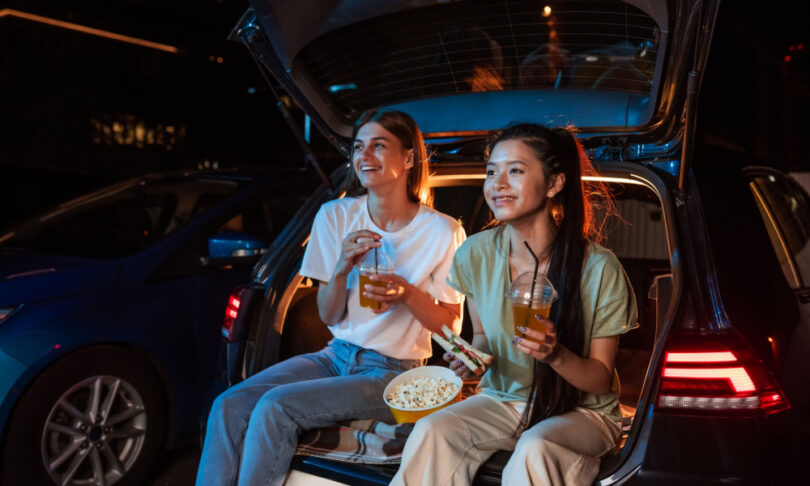 girls enjoying a movie outdoors