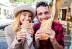 Couple eating sandwiches