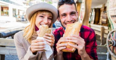 Couple eating sandwiches